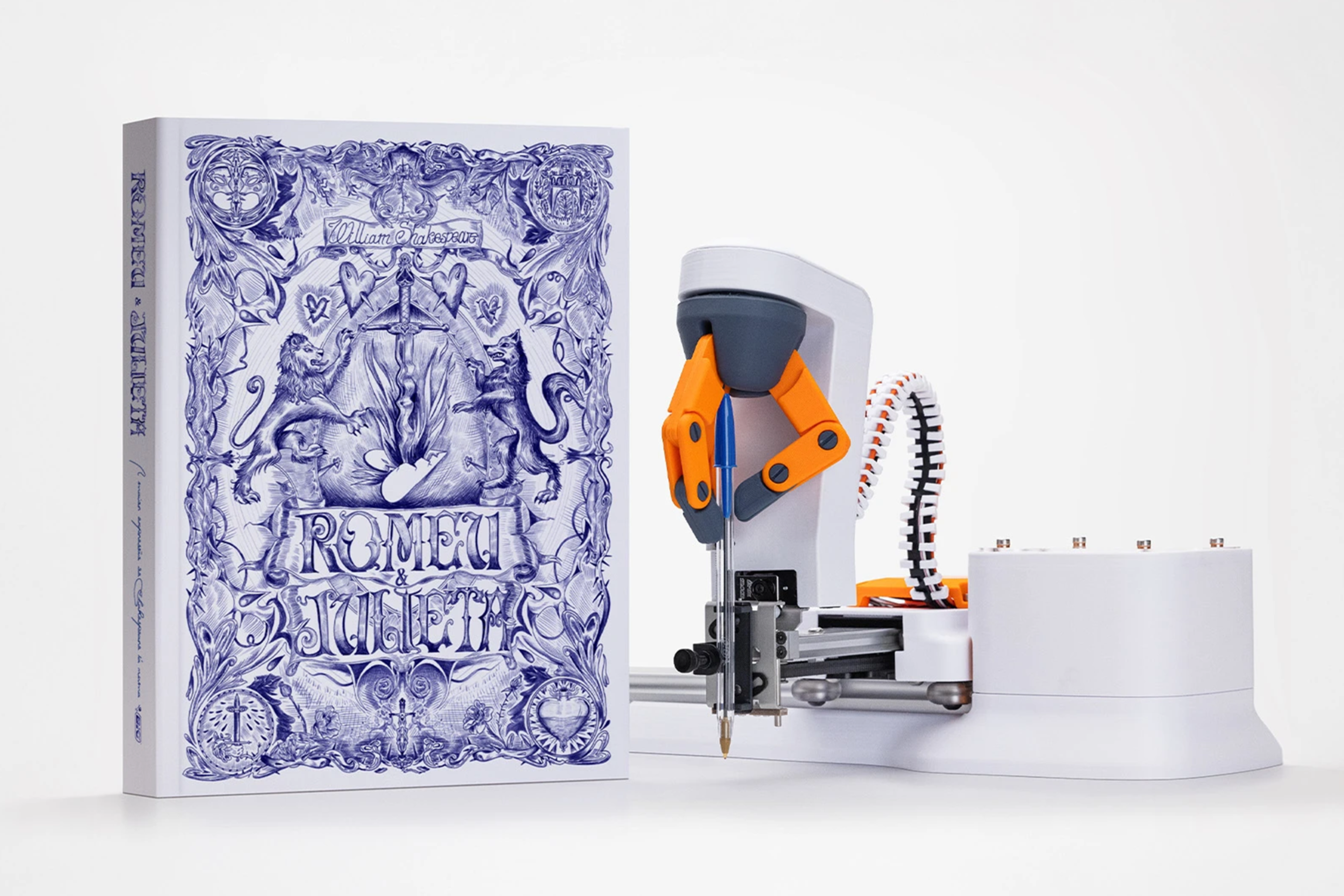 A decorated Romeo and Juliet volume stands beside a robotic arm holding a blue BIC pen.