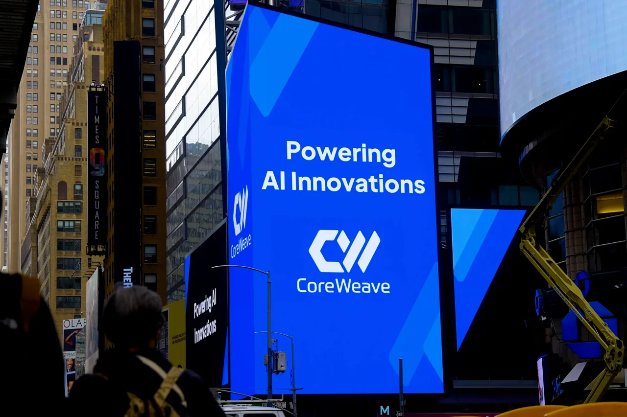 A blue CoreWeave billboard in Times Square reads ‘Powering All Innovations.’