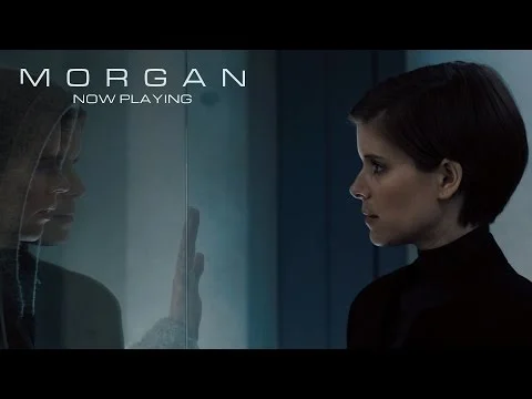 Two characters face each other through glass beneath the Morgan title in the official trailer thumbnail.